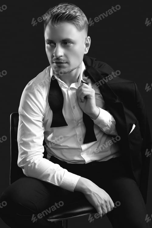 Preview: Portrait Of Handsome Blond Man In Elegant Tuxedo And Bow Tie Posing On Black Studio Background