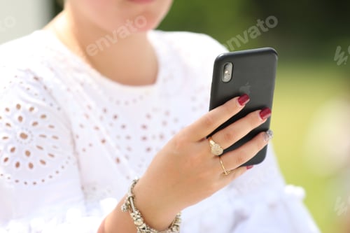 Preview: A young woman using mobile phone
