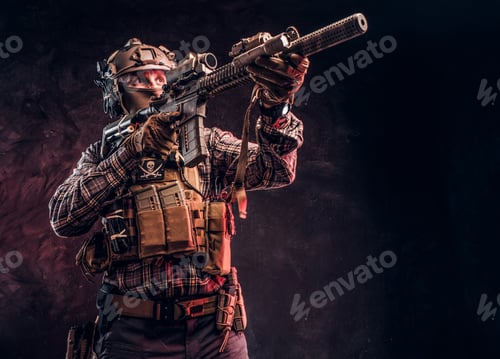 Preview: Special forces soldier in camouflage uniform holding an assault rifle with a laser sight
