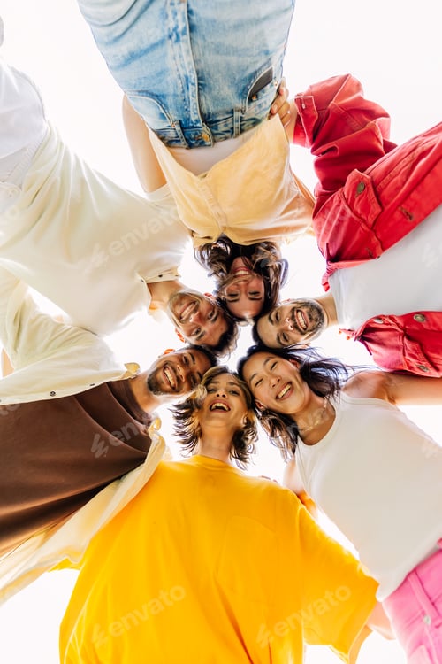 Preview: Low angle view of happy group of young people in circle smile at camera
