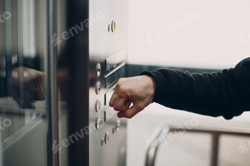 Preview: Close up of forefinger pressing the button elevator during coronavirus pandemic covid-19