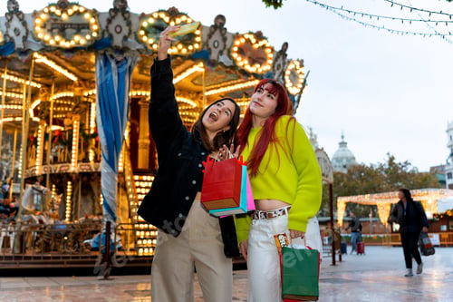 Preview: Gen z friends taking selfie during christmas shopping