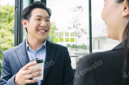 Preview: Asian business people colleagues talking in the office with cups of coffee