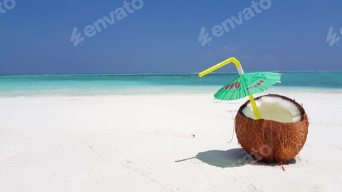 Preview: Closeup of a tasty coconut cocktail at a beach on a sunny day