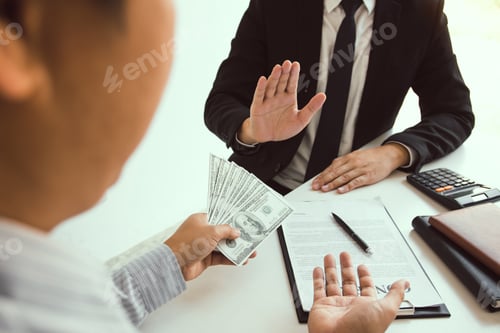 Preview: Business person refusing bribe given money by partner with anti bribery corruption concept.