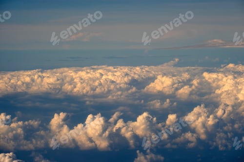Preview: Aerial view from above at high altitude of dense puffy cumulus clouds