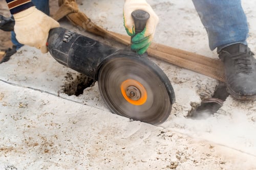Preview: Close up worker cuts concrete with circular saw