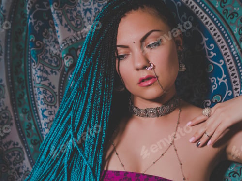 Preview: Portrait of young beautiful woman with blue kanekalon braided hairstyle in Indian jewelry and saree