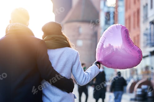 Preview: Happy couple celebrating Valentines Day in masks during covid-19 pandemic