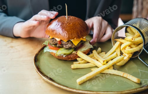 Preview: Close-up, appetizing burger and french fries in a cafe.