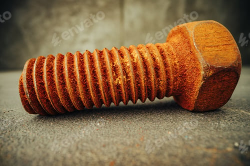 Preview: Old rusty bolt on grey background macro
