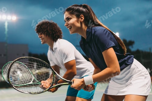 Preview: Tennis sport people concept. Mixed doubles player hitting tennis ball with partner standing near net