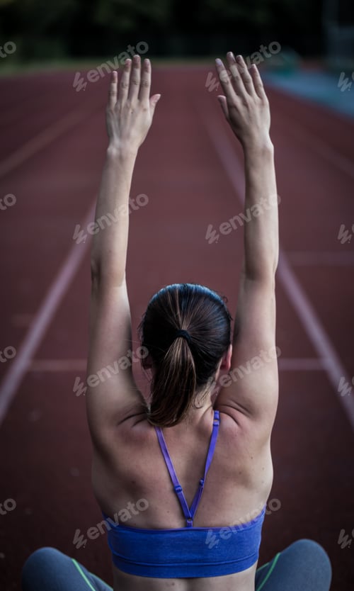 Preview: beautiful sporty girl warming up at the stadium,