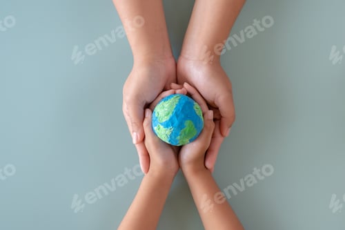 Preview: Hands holding earth paper and water paint. Concept of sustainability environment protection