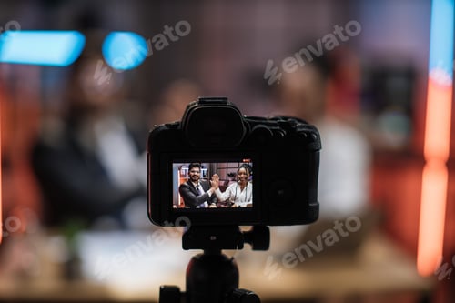 Preview: View from screen of camera with positive multiracial partners giving high five