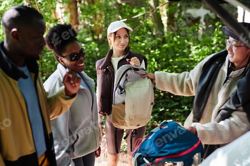 Preview: Tourists Unloading Hiking Gear From Car