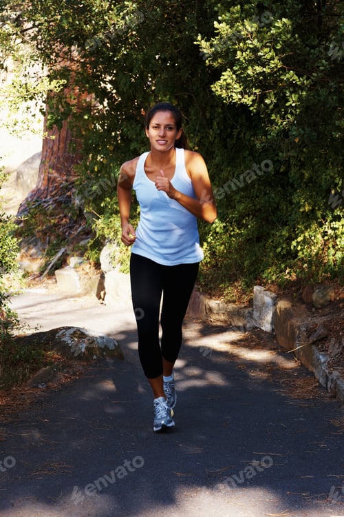 Preview: Young woman jogging. Full length of young healthy woman jogging outdoors.