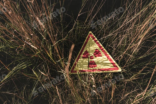 Preview: top view of triangle with warning toxic symbol on grass, post apocalyptic concept