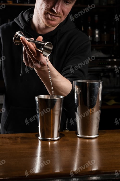 Preview: Bartender shaking Clover Club cocktail at bar