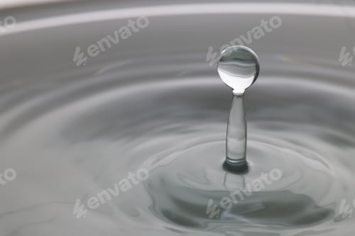 Preview: Splash of clear water with drop on light grey background, closeup. Space for text