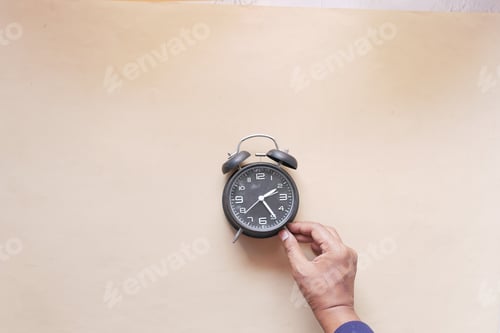Preview: old alarm clock on color background.