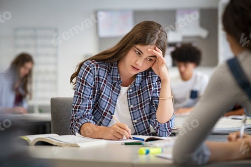 Preview: Stressed and worried girl durig exam at school