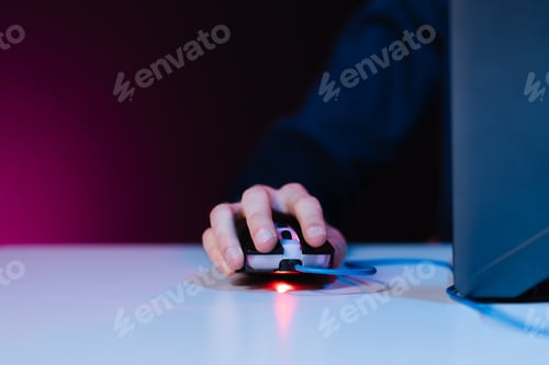 Preview: Human hand pressing computer mouse with flash of light on background