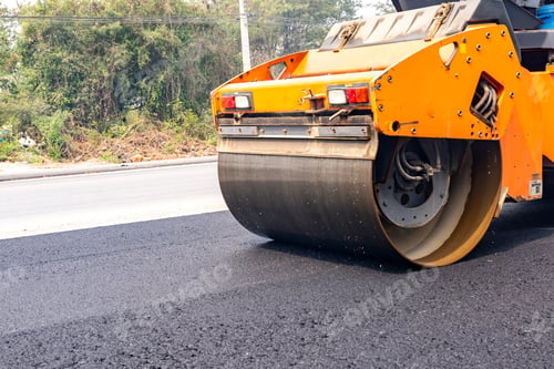 Preview: Machines are crushing the asphalt after pouring to make a road for cars.