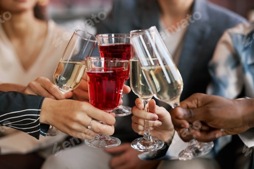 Preview: Focus on flutes with fizzy champagne and wineglasses with red wine
