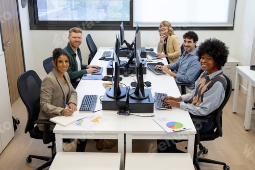 Preview: Diverse business team collaborating in shared office space