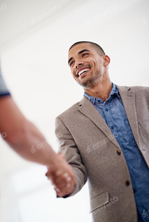 Preview: Welcome to the big leagues. Low angle shot of two colleagues shaking hands.