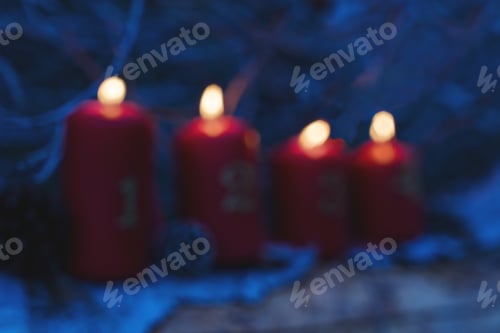 Preview: Defocused Four red advent candles as Catholic symbol of Christmas