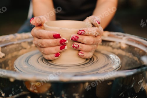 Preview: Pottery wheel session with smiling girl shaping clay