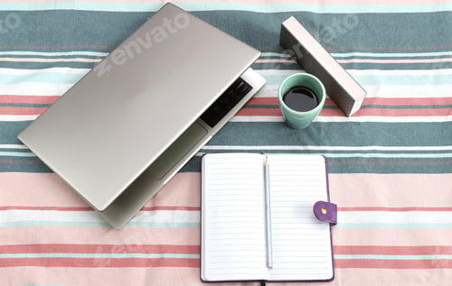 Preview: Modern home office or work place with laptop, notebook and coffee, Top view with copy space,