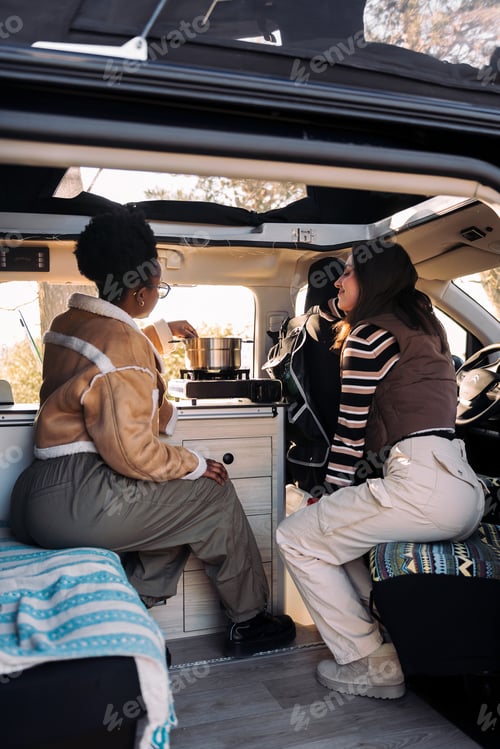 Preview: friends in a road trip cooking in camper van