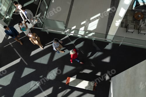 Preview: High angle view of business people arriving at office lobby