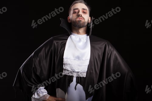 Preview: Scary man in dracula costume for halloween looking confident into the camera