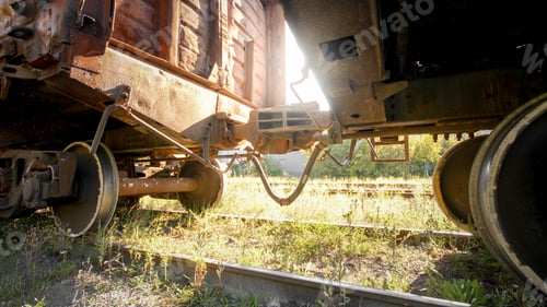 Preview: Image of coupler connecting and pairing two cargo train cars on railroad at susnet