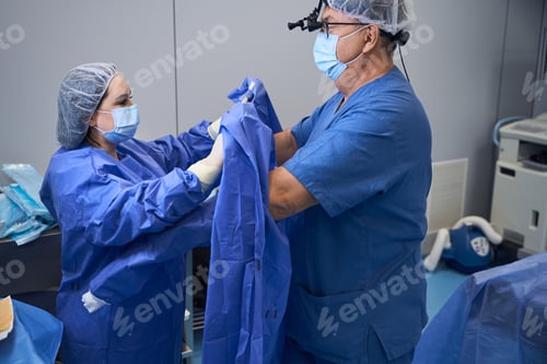 Preview: Surgeons Preparing Sterile Drapes in Operating Room