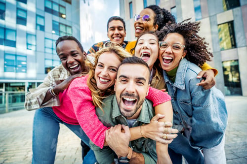 Preview: Multi ethnic young people smiling together at camera outdoors