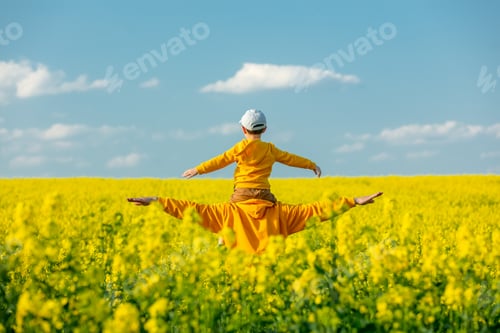 Preview: Father with a son in rapeseed field in spring time