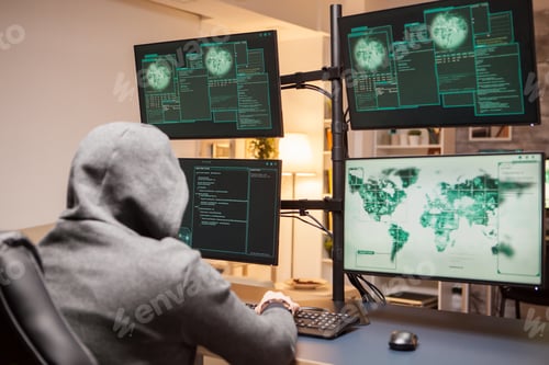 Preview: Dangerous hacker wearing a hoodie while planting a malware