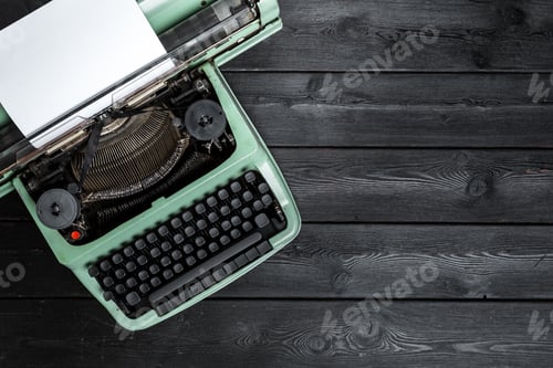 Preview: Old typewriter sits on a wooden table with a blank paper ready for writing in a cozy space