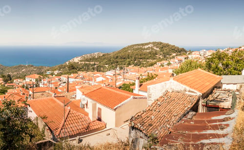 Preview: Panoramic view of a quaint coastal village overlooking the sea with terracotta rooftops