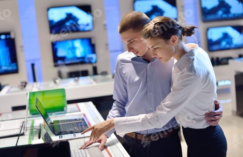 Preview: People In Consumer Electronics Retail Store Looking At Latest Laptop, Television And Photo Camera