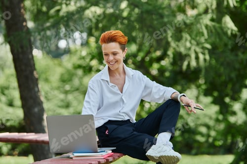 Preview: Smiling Woman Works On Laptop In Campus Park