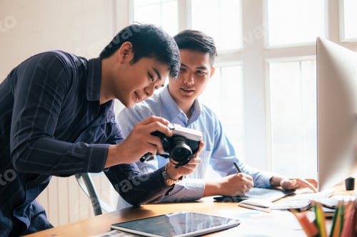 Preview: Young startup business teamwork. Photographer and graphic designer select and editing images.