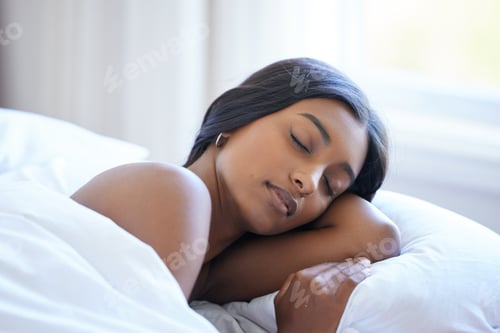 Preview: Sweet dreams. High angle shot of an attractive young woman sleeping peacefully in bed.