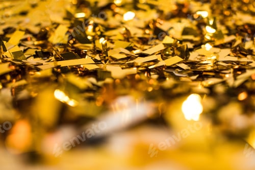 Preview: Close up of golden shiny confetti pieces