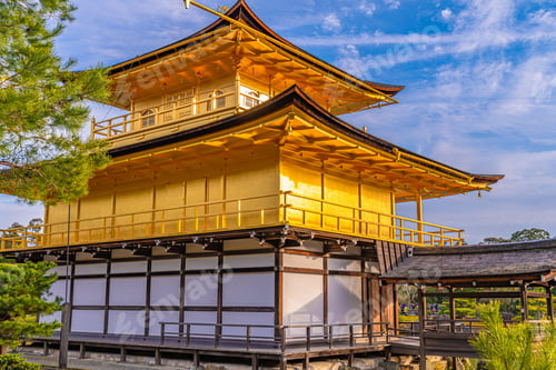 Preview: Closeup of golden temple of Kinkaku-ji in Kyoto, Japan against a cloudy blue sky